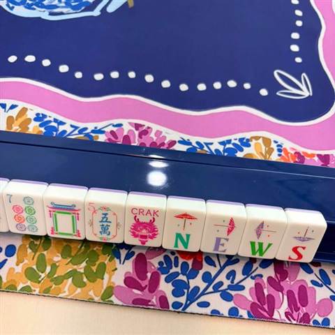 Lavender-backed tiles and a joker on a floral mat