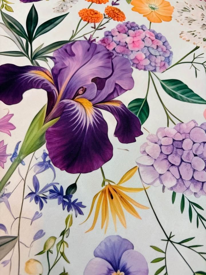 Purple layered tiles on a mat covered in irises, dahlias, and passion flowers