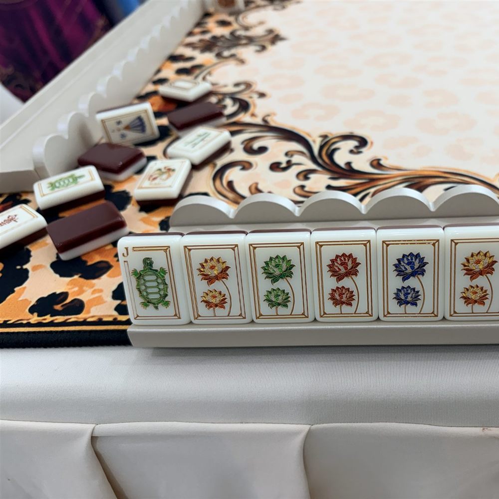 A rack of flower tiles on a leopard and gold scroll mat