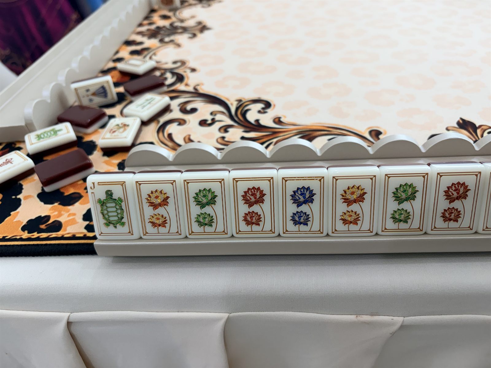 A rack of flower tiles on a leopard and gold scroll mat